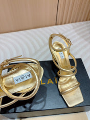 ALAIA THREE-STRAPS HIGH HEEL SANDALS IN GOLDEN PATENT LAMBSKIN