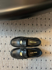 MIUMIU 26S PENNY LOAFERS IN BLACK CALFSKIN GOLD HARDWARE