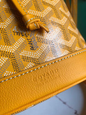 PETIT FLOT BUCKET BAG 22 IN YELLOW GOYARDINE CANVAS AND LAMBSKIN TRIM