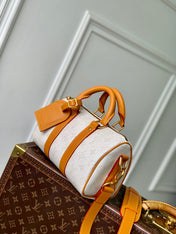 KEEPALL BANDOULIÈRE 25 IN WHITE MONOGRAM HERITAGE CANVAS BRWON CALFSKIN