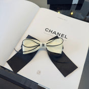 CHANEL 26S BOW HAIR CLIP IN BLACK AND WHITE SATIN 503132