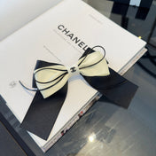 CHANEL 26S BOW HAIR CLIP IN BLACK AND WHITE SATIN 503132
