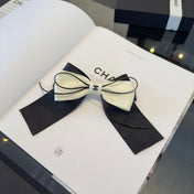 CHANEL 26S BOW HAIR CLIP IN BLACK AND WHITE SATIN 503132
