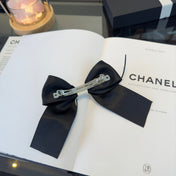 CHANEL 26S BOW HAIR CLIP IN BLACK AND WHITE SATIN 503132