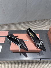 MIUMIU 26S POINTED TOE PUMPS 55MM IN BLACK AND WHITE CALFSKIN WITH BOW