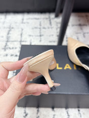 ALAIA 26S HEELED MULES 65 MM IN IVORY BEIGE SATIN