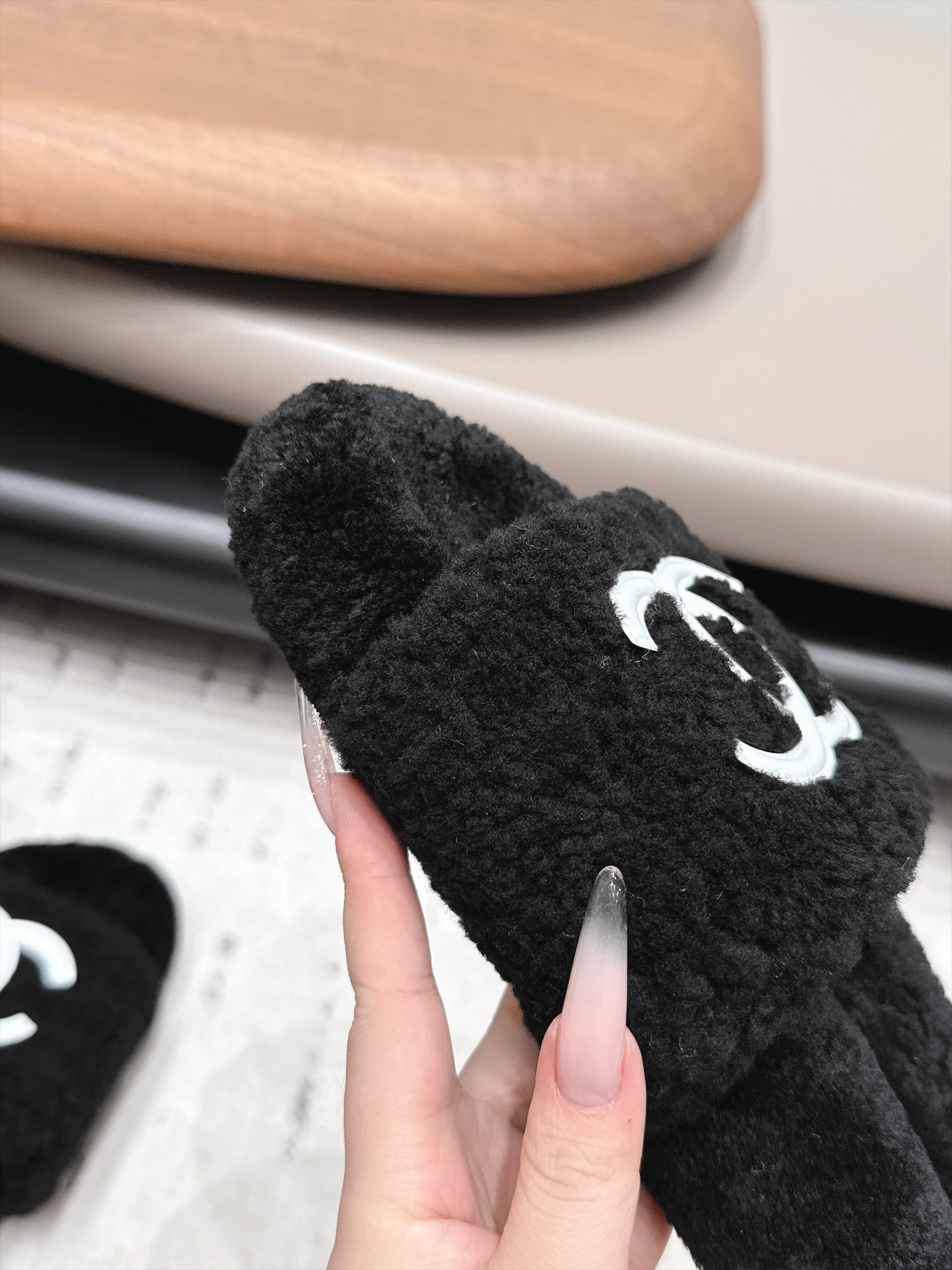 CHANEL 26S SLIDE MULES IN BLACK SHEARLING AND WHITE CC LOGO