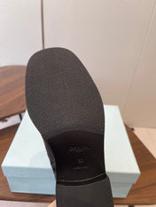 PRADA 25S COWBOY BOOTS IN DARK BLACK-BROWN CALFSKIN
