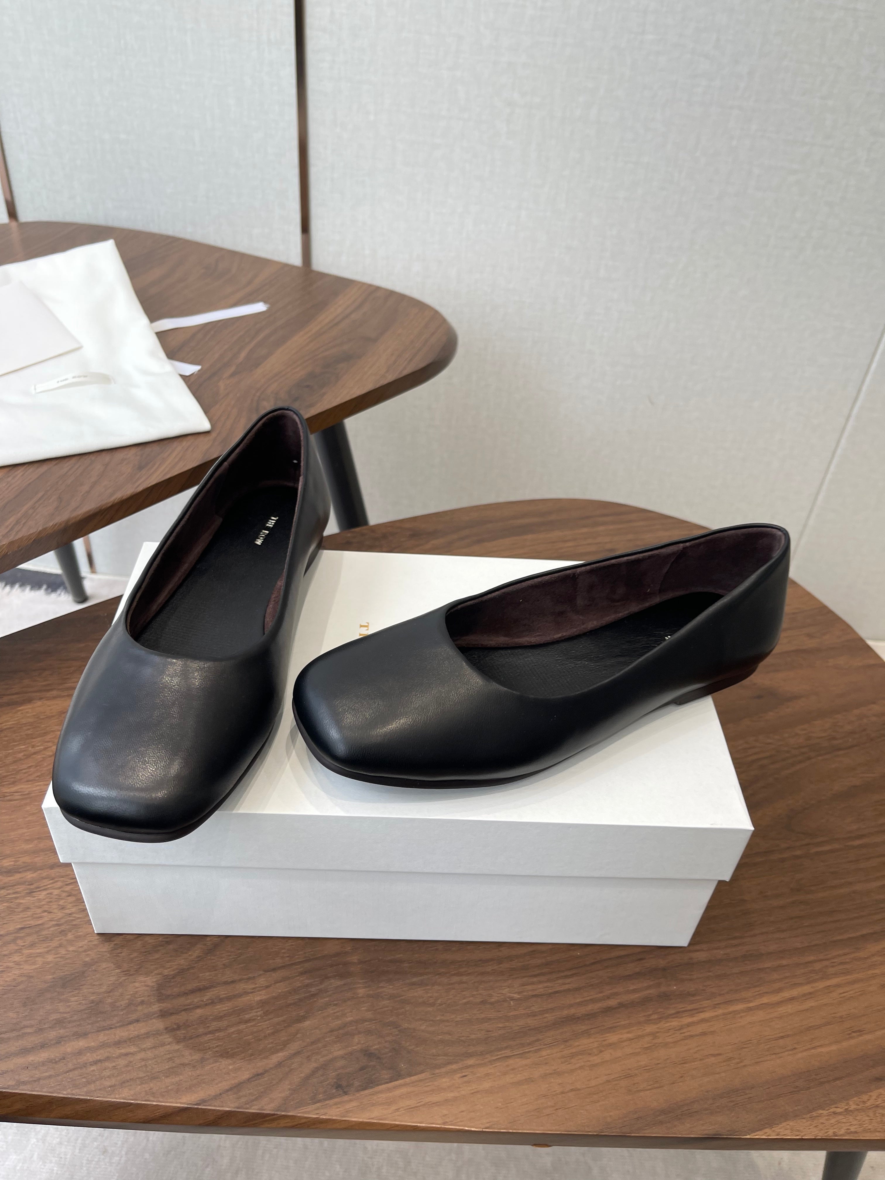 THE ROW 26S FLATS IN BLACK CALFSKIN