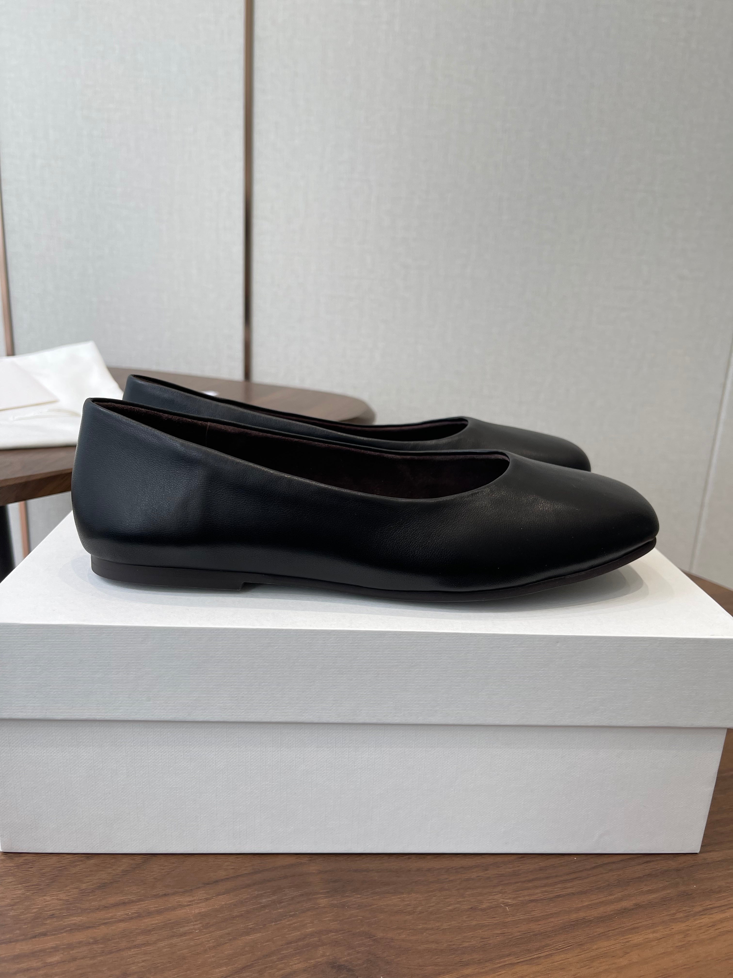 THE ROW 26S FLATS IN BLACK CALFSKIN