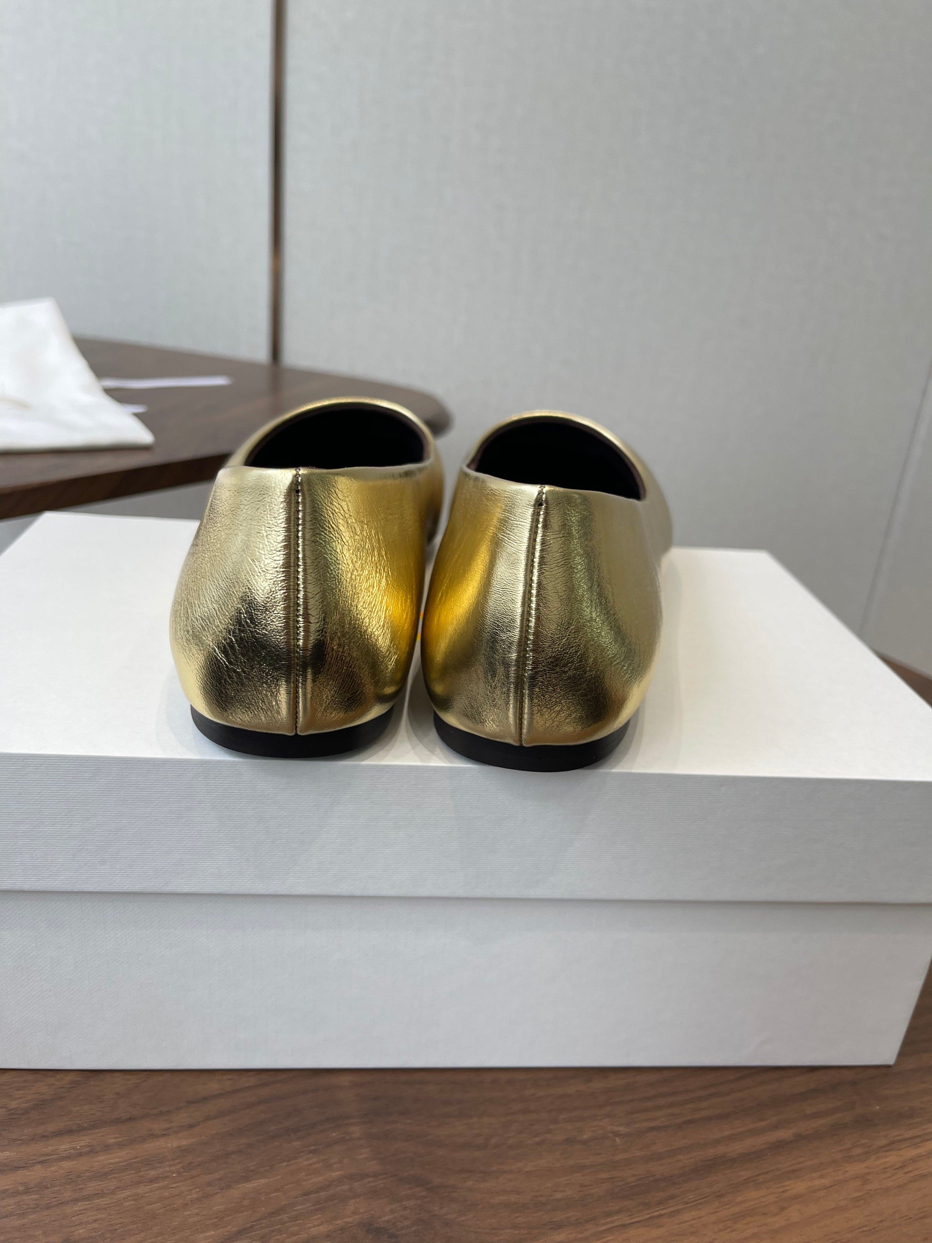 THE ROW 26S FLATS IN GOLD CALFSKIN