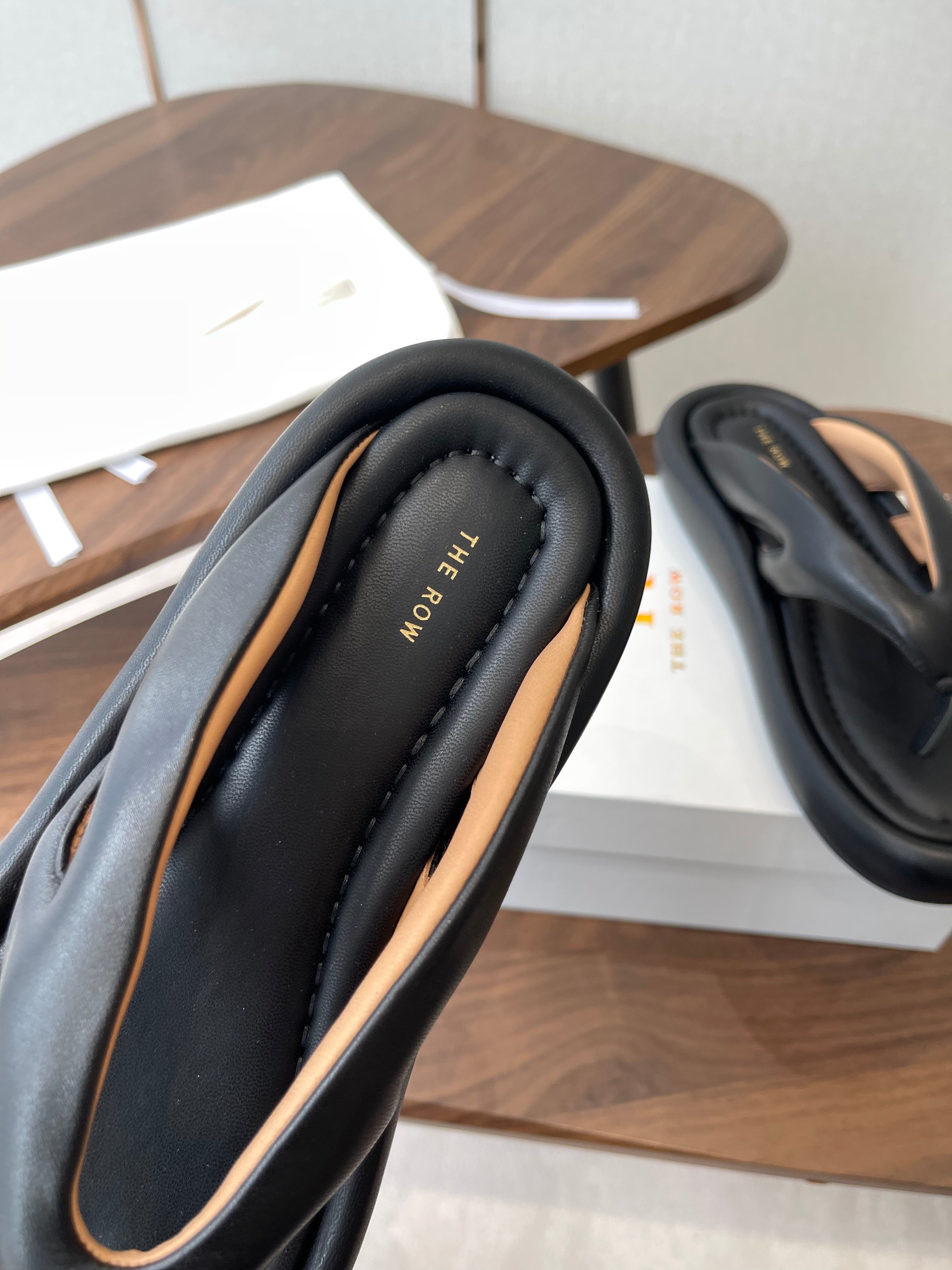THE ROW 26S PUFFED THONG SANDALS IN BLACK CALFSKIN