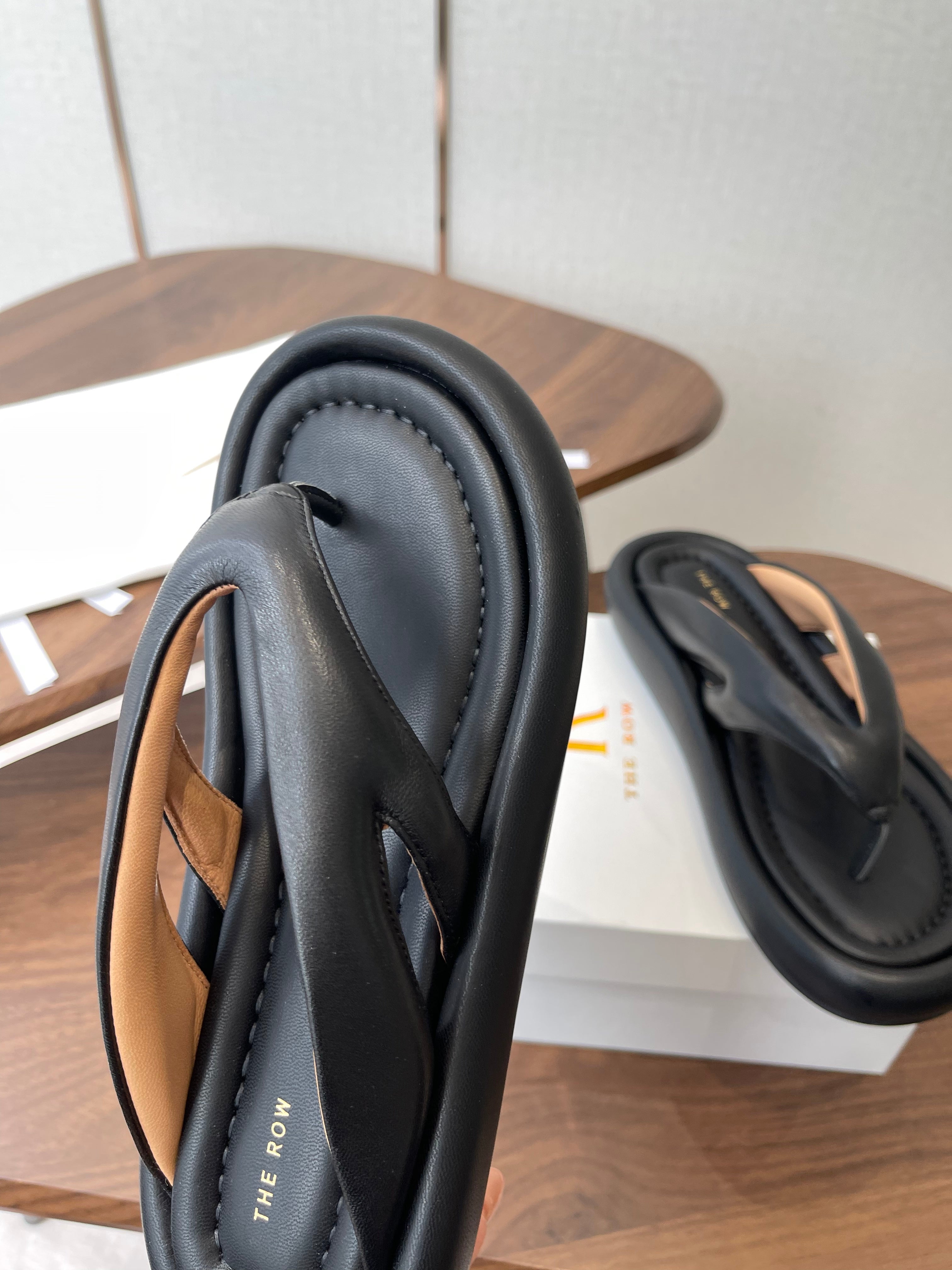 THE ROW 26S PUFFED THONG SANDALS IN BLACK CALFSKIN