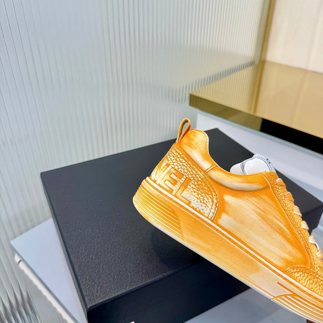 CHANEL 26S LOW-TOP SNEAKERS IN GOLDEN ORANGE CALFSKIN