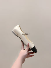 CHANEL 25S MARY JANE FLATS IN IVORY LAMBSKIN WITH BLACK CAP TOE SILVER HARDWARE