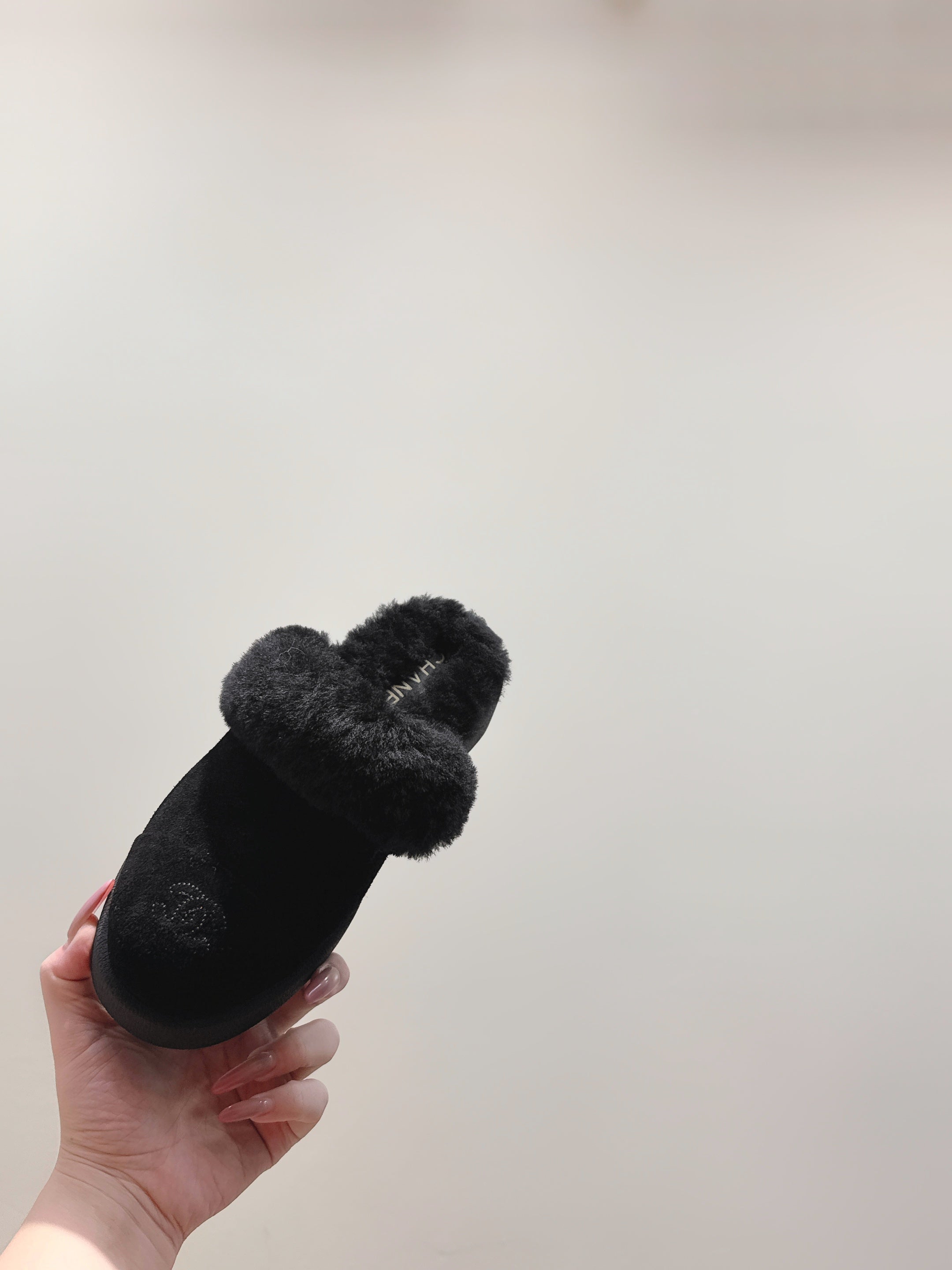 CHANEL 25S FUR-LINED MULES IN BLACK SUEDE