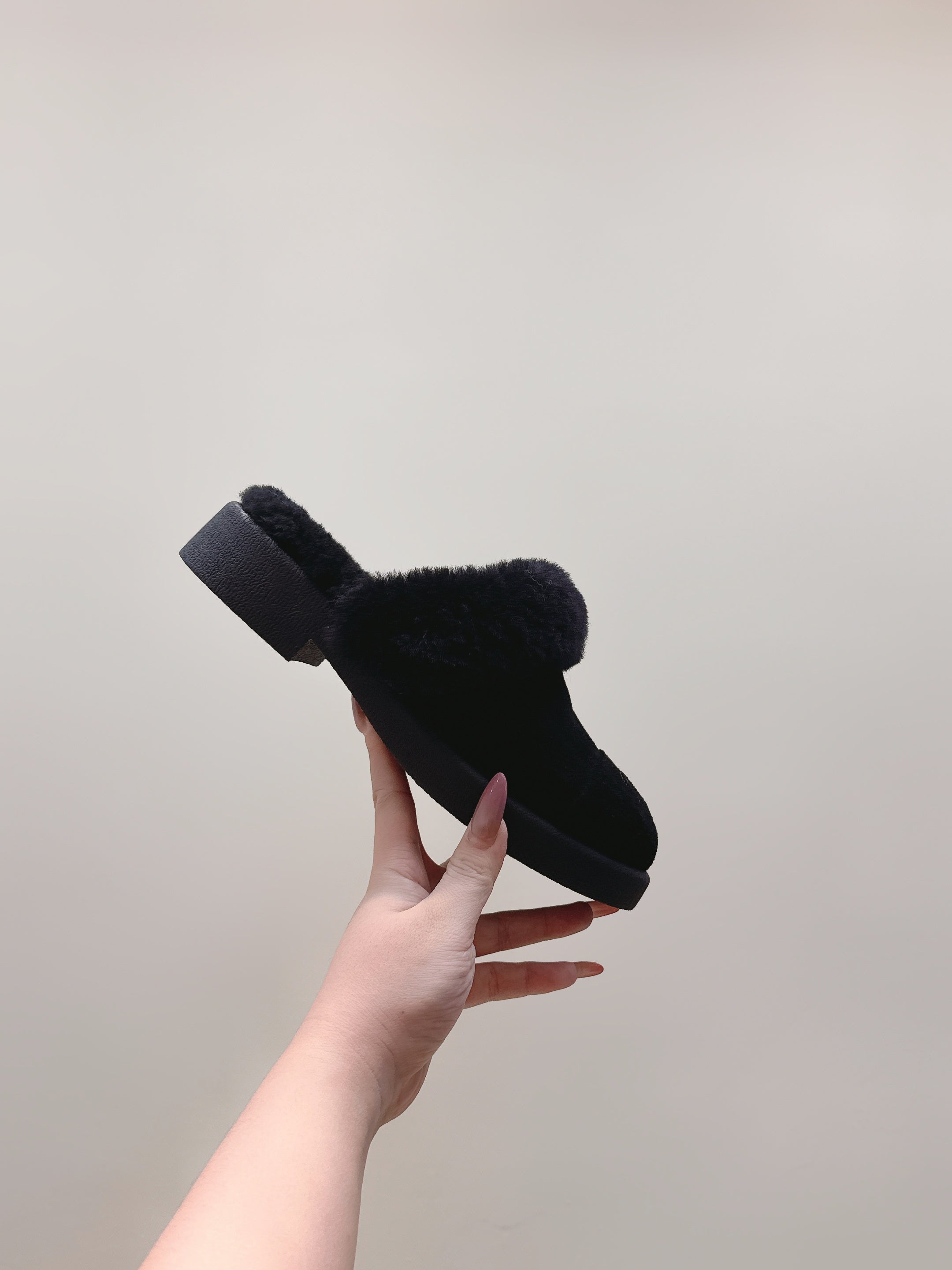 CHANEL 25S FUR-LINED MULES IN BLACK SUEDE