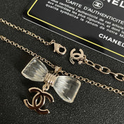 CHANEL 26S DOUBLE C LOGO CLEAR BOW PENDANT NECKLACE IN GOLD METAL 629174