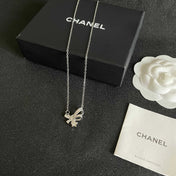 CHANEL 26S DOUBLE C LOGO CRYSTAL BOW & STAR PENDANT NECKLACE IN SILVER METAL 631019
