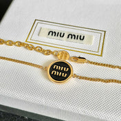 MIUMIU 26S LOGO ROUND BRACELET IN BLACK ENAMEL AND GOLD TONE METAL 631809