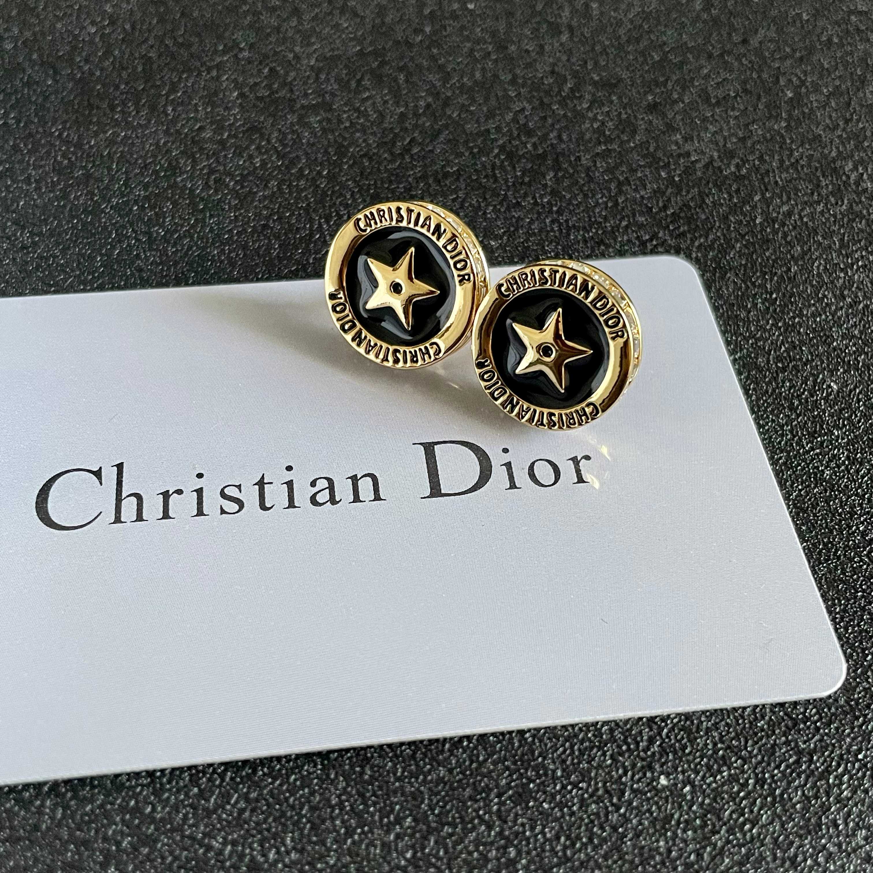 CD 26S STAR MEDALLION LOGO STUD EARRINGS IN BLACK ENAMEL & GOLD TONE METAL 631813