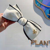 BOW HAIRPIN IN WHITE AND BLACK TRIM COTTON 406023