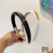 HEADBAND IN BLACK PATENT CALFSKIN SILVER LOGO 427344