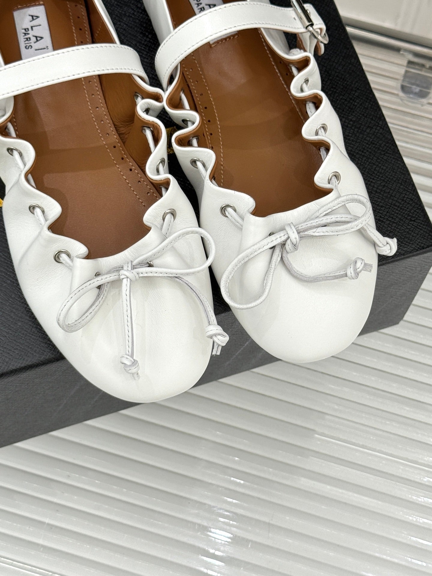 ALAIA 26S MARY JANE FLATS IN WHITE LAMBSKIN WITH BOW
