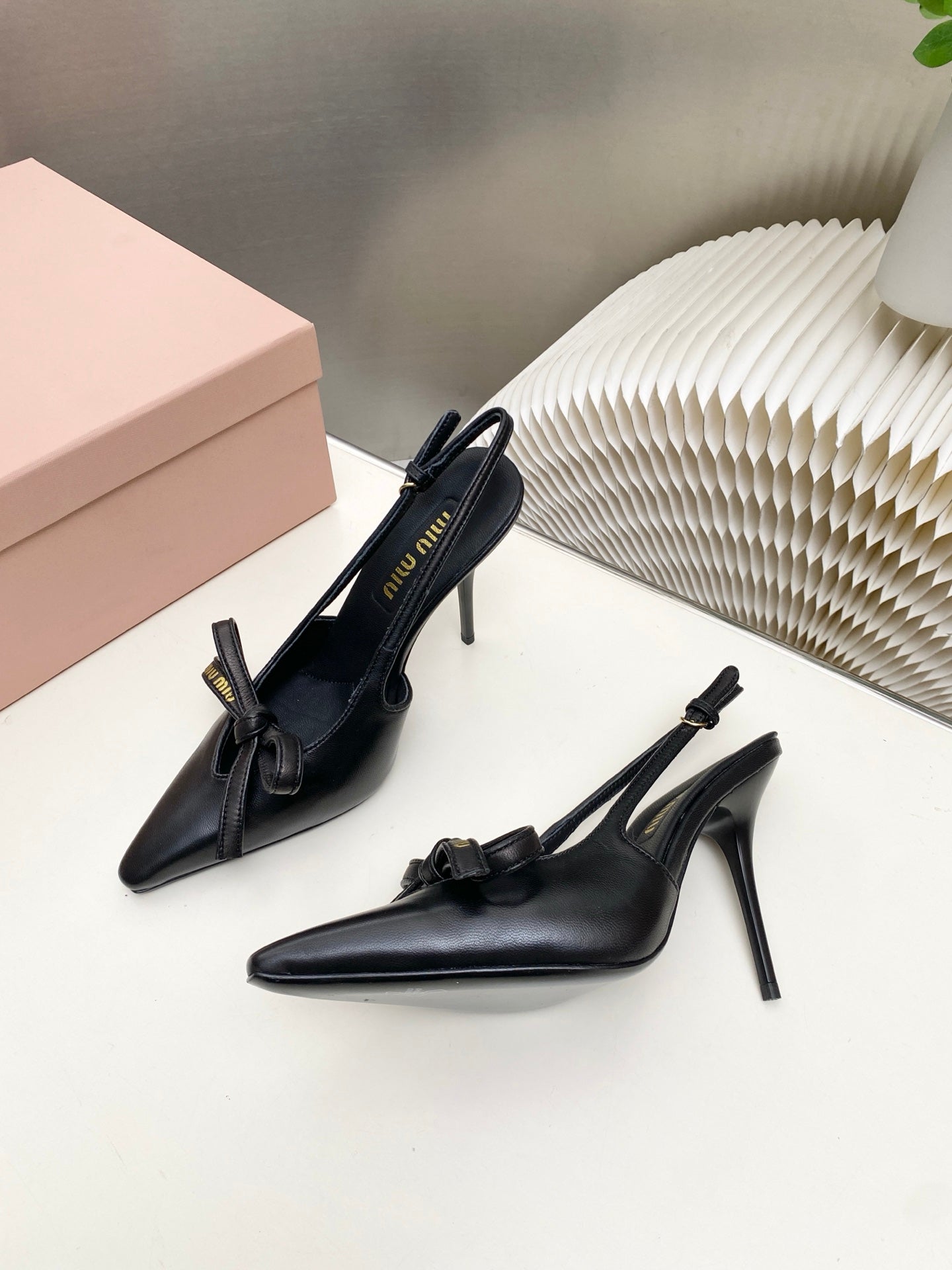 MIUMIU 26S SLINGBACK PUMPS 105MM IN BLACK CALFSKIN WITH BOW