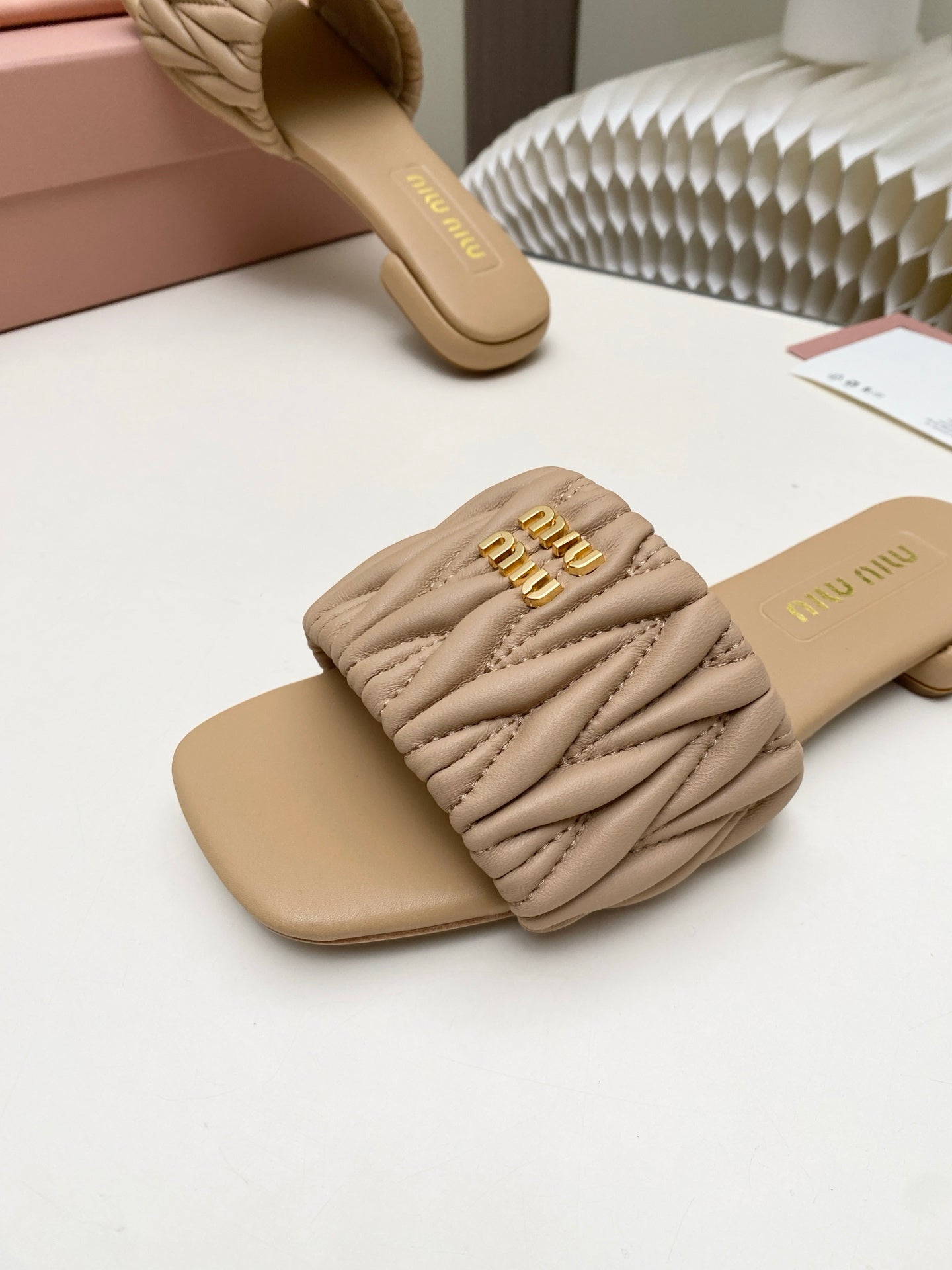 MIUMIU 26S MATELASSE SLIDES IN BEIGE CALFSKIN