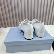 PRADA 26S T-STRAP MARY JANE PUMPS 40MM IN LIGHT BLUE PATENT CALFSKIN WITH BOW