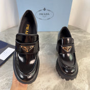 PRADA 26S HEELED LOAFERS 85 MM IN BLACK CALFSKIN