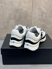 CHANEL 26S RUNNER CC LOGO SNEAKERS IN WHITE AND BLACK CALFSKIN
