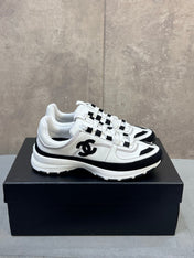 CHANEL 26S RUNNER CC LOGO SNEAKERS IN WHITE AND BLACK CALFSKIN