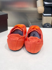 PRADA 26S SNEAKERS IN BURNT ORANGE SATIN