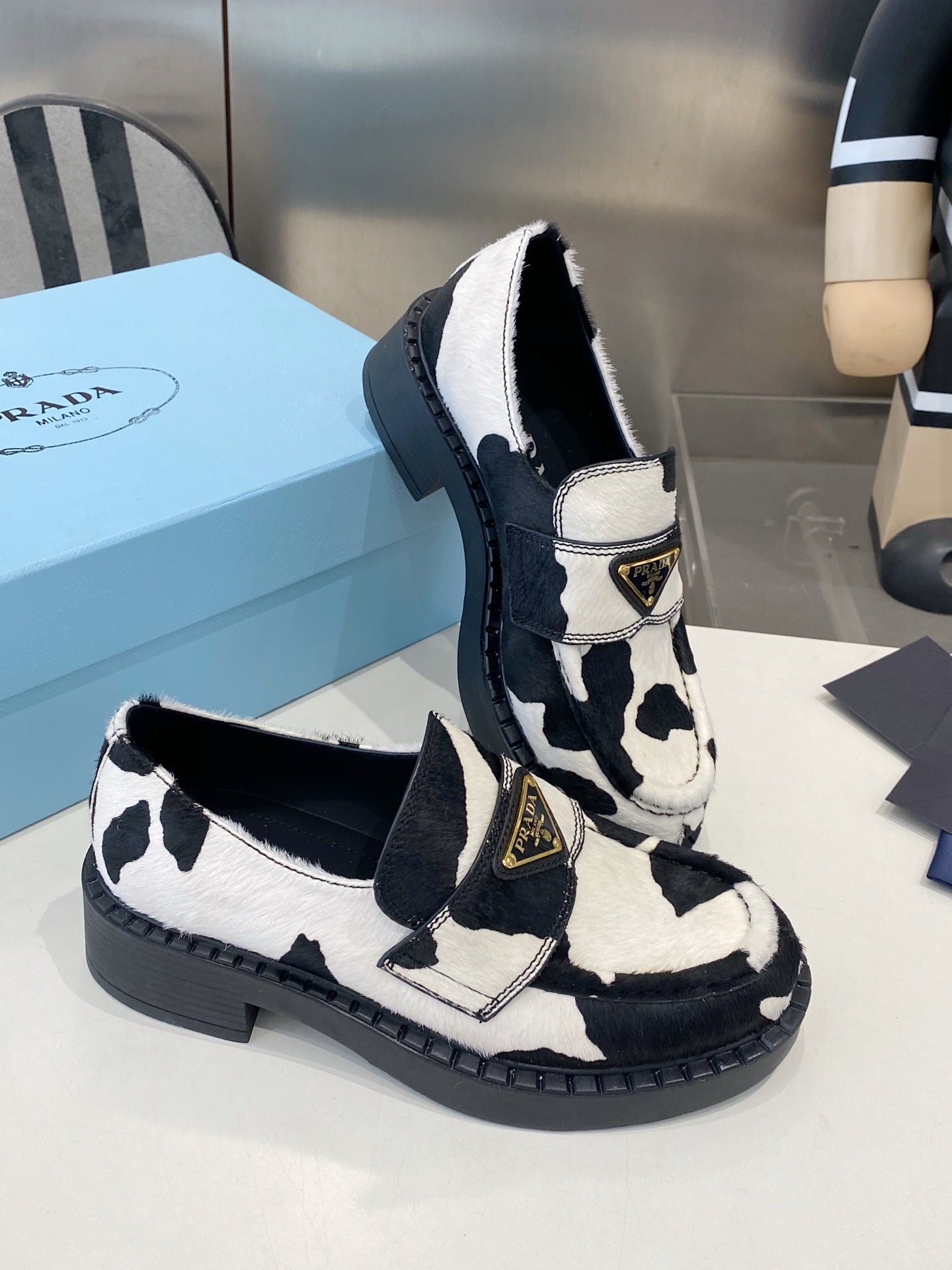 PRADA 26S LOAFERS IN WHITE AND BLACK COW PRINT PONY HAIR