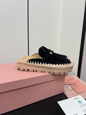 MULES SLIPPERS IN BLACK SUEDE WITH GOLD COIN