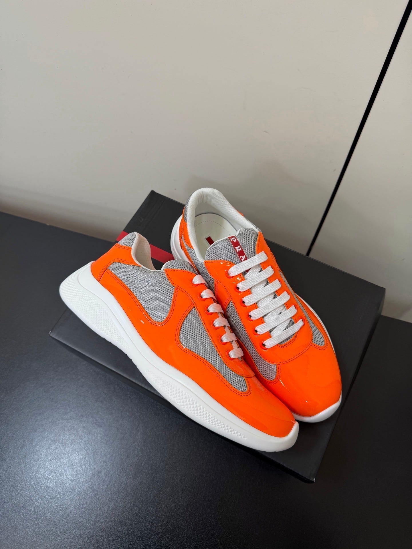 PRADA 26S SNEAKERS IN ORANGE PATENT CALFSKIN AND WHITE MESH