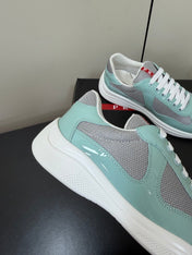 PRADA 26S SNEAKERS IN SOFT TEAL PATENT CALFSKIN AND WHITE MESH