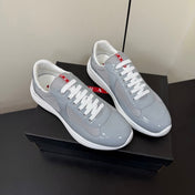 PRADA 26S SNEAKERS IN LIGHT GRAY PATENT CALFSKIN AND WHITE MESH