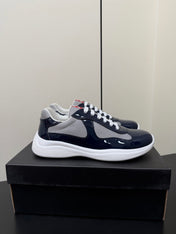 PRADA 26S SNEAKERS IN NAVY BLUE PATENT CALFSKIN AND WHITE MESH