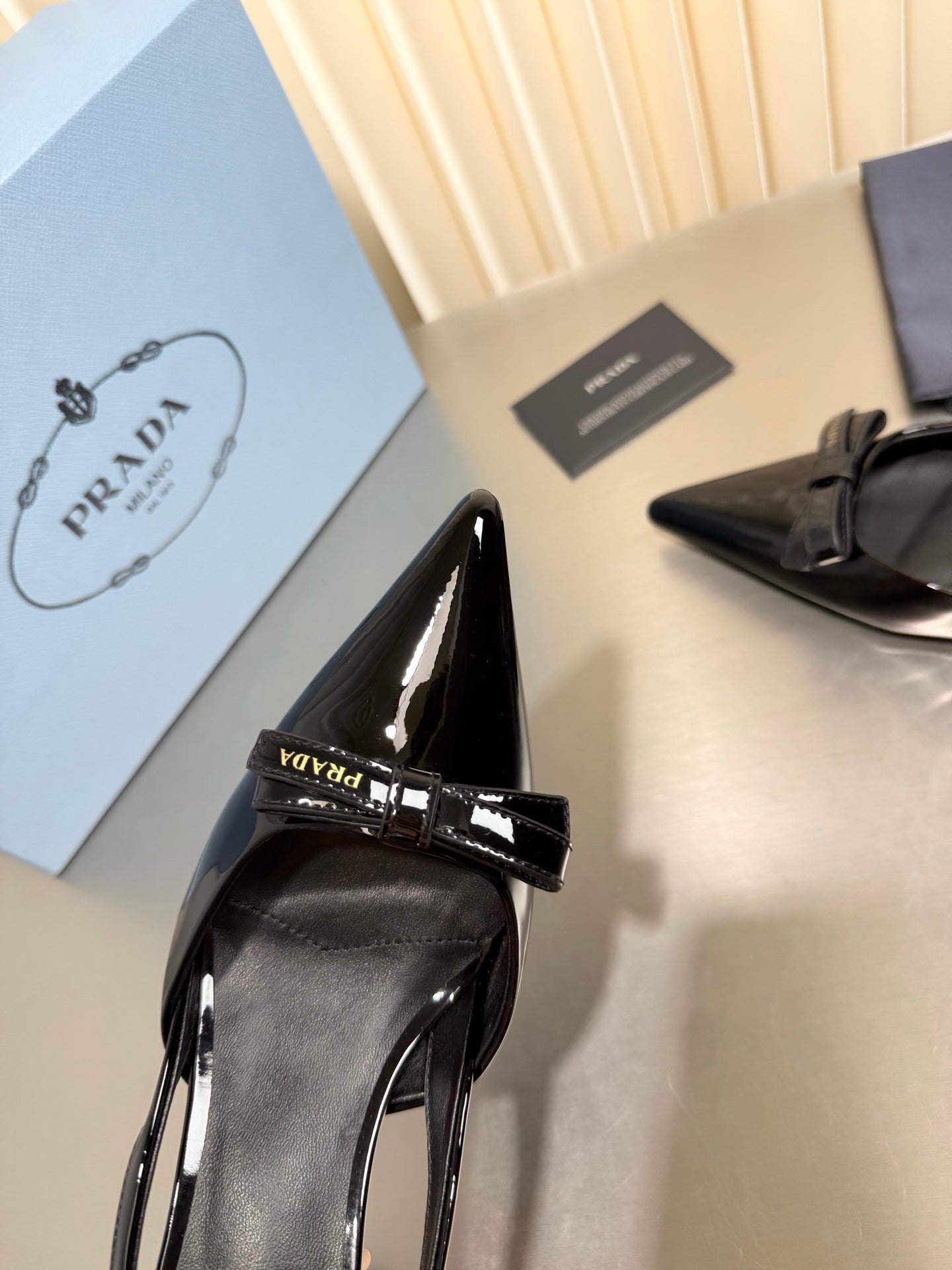 PRADA 26S POINTED-TOE SLINGBACK PUMPS IN BLACK PATENT CALFSKIN WITH BOW