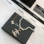 CHANEL 26S CHANEL CC LOGO PEARL BEADED NECKLACE WITH CHARM DETAIL IN GOLD METAL 633323