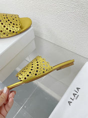 ALAIA VIENNE FLAT MULES IN GOLDEN LAMBSKIN