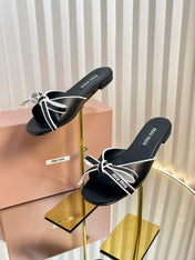 SLIDES SANDALS IN BLACK WITH WHITE BORDER CALFSKIN BOW IN TRAP