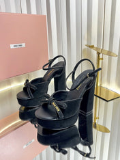 MIUMIU 26S PLATFORM ANKLE STRAP SANDALS 120MM IN BLACK SUEDE WITH BOW