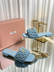 MIUMIU 26S MATELASSE SLIDES IN LIGHT BLUE CALFSKIN GOLD HARDWARE
