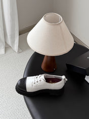 CHANEL 26S LACE UP PLATFORM IN BLACK AND WHITE CALFSKIN