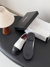 CHANEL 26S LACE UP PLATFORM IN BLACK AND WHITE CALFSKIN