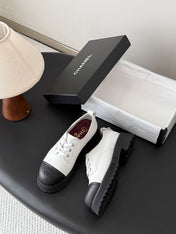 CHANEL 26S LACE UP PLATFORM IN BLACK AND WHITE CALFSKIN